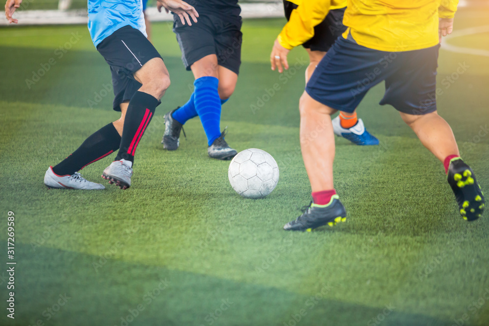 Selective focus to soccer player speed run to control and shoot ball to goal. Soccer players fighting each other by kicking the ball. Selective focus to soccer player speed run to control and shoot ball to goal. Soccer players fighting each other by kicking the ball.