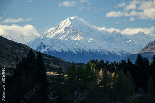 Snow covered Mount Cook with blue sky and white clouds, South Island, New Zealand