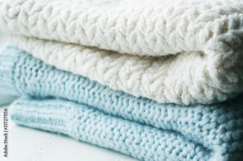 Knitting. Patterns. Natural yarn. Cotton. Wool. White and blue background.