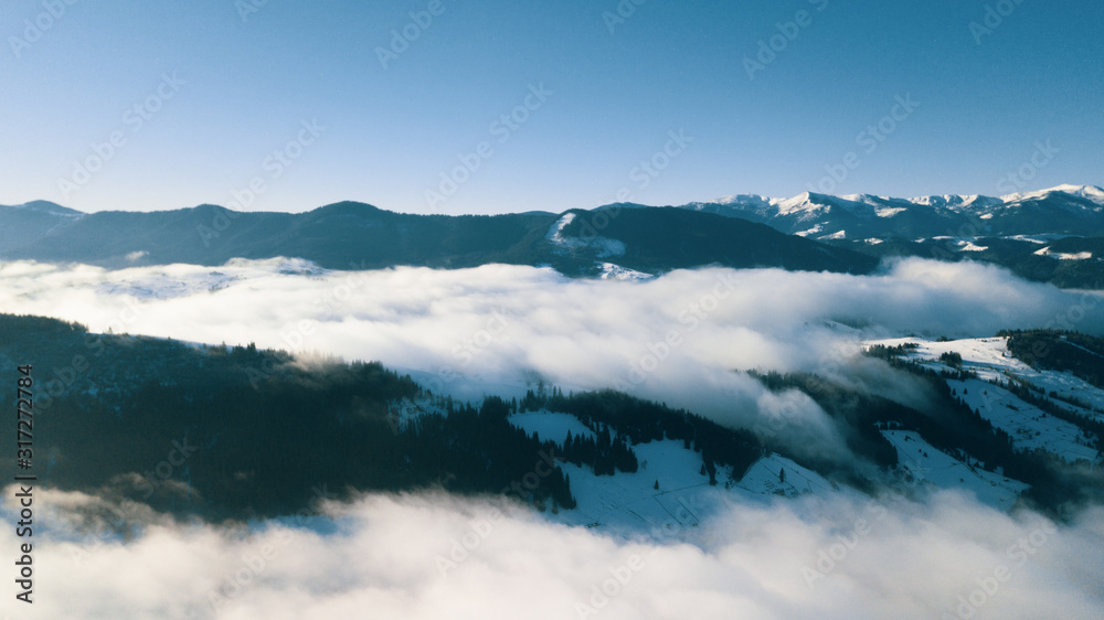 Beautiful landscape with mountain peaks covered with snow and clouds Beautiful landscape with mountain peaks covered with snow and clouds