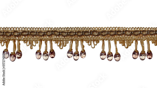 The fringe is light brown in color with eyelets and beads below. Separate on a white background. Decor, design, decoration, texture.