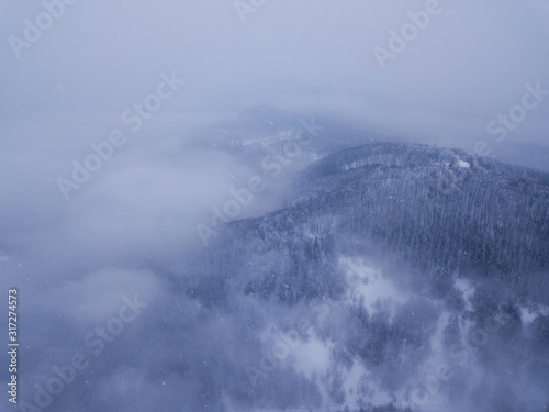 Beautiful landscape with mountain peaks covered with snow and clouds