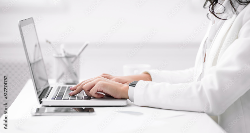 Unrecognizable latin girl working on her laptop at office Unrecognizable latin girl working on her laptop at office