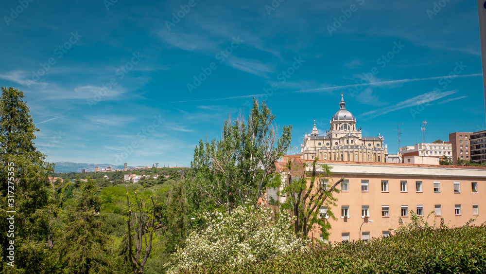 Panoramic view of Almudena cathedral from the famous park Las Vistillas in the downtown Madrid, Spain on a sunny day during the traditional festival in May called San Isidro in the capital of Spain