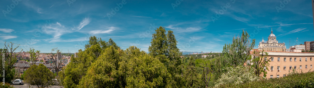 Panoramic view of Almudena cathedral from the famous park Las Vistillas in the downtown Madrid, Spain on a sunny day during the traditional festival in May called San Isidro in the capital of Spain Panoramic view of Almudena cathedral from the famous park Las Vistillas in the downtown Madrid, Spain on a sunny day during the traditional festival in May called San Isidro in the capital of Spain