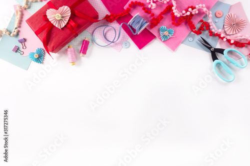 Valentines day and 14 february holidays banner. Gift wrapping workspace. Decoration presents making flat lay top view celebration preparation DIY concept decor on white background. photo