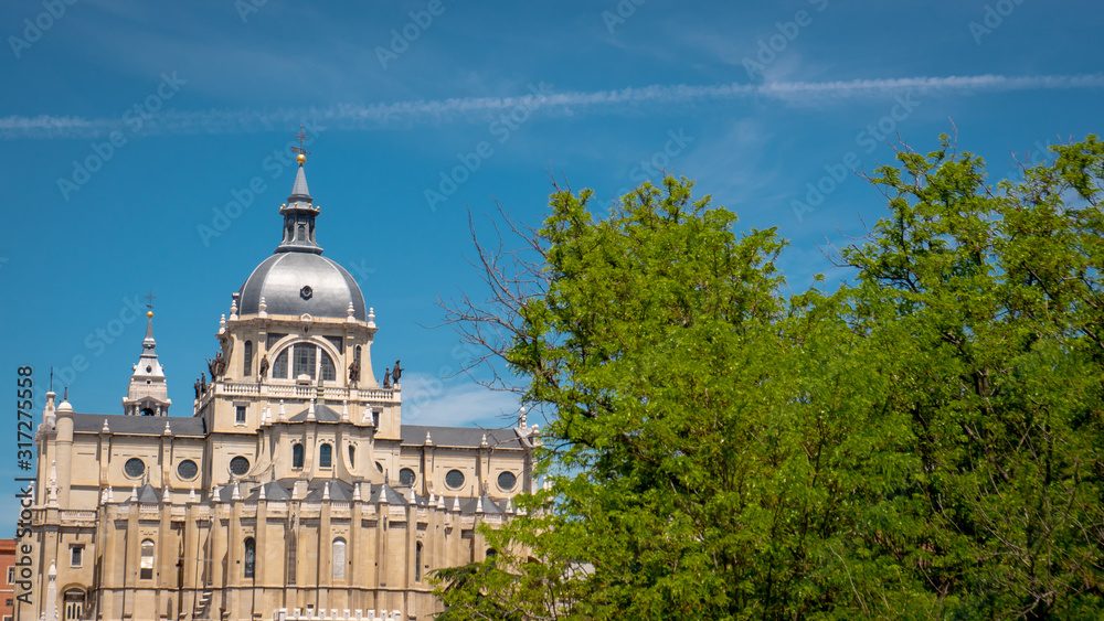 Panoramic view of Almudena cathedral from the famous park Las Vistillas in the downtown Madrid, Spain on a sunny day during the traditional festival in May called San Isidro in the capital of Spain