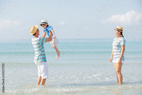 Happy asian family enjoy on the beach together