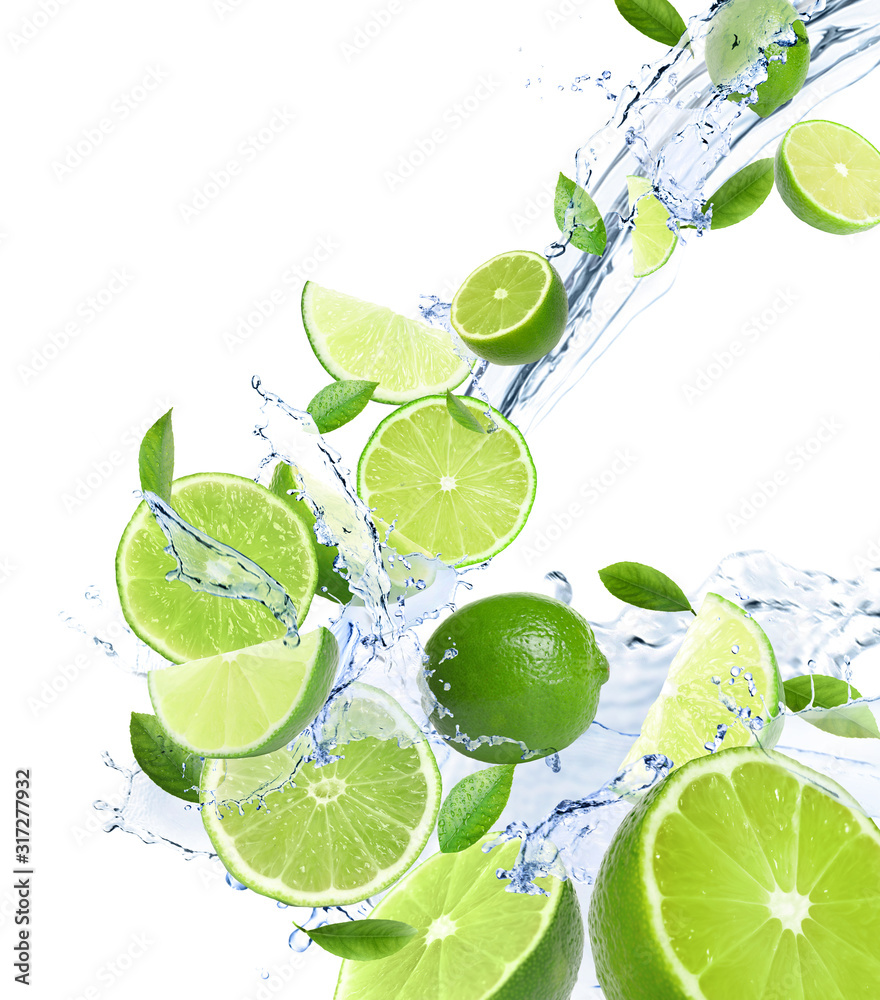 Ripe limes, fresh mint and splashing water on white background