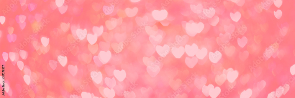 Creative wide pink banner of bokeh in shape of hearts. 