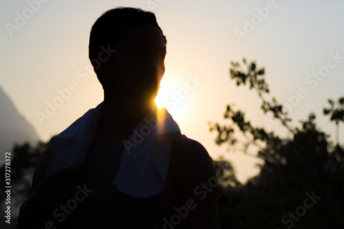 Silhouette of Asian Man in Sunset Glow