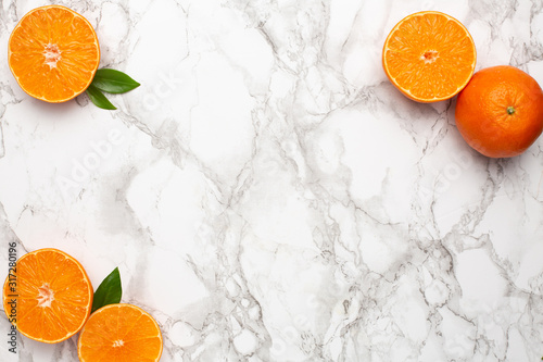 Fresh orange mangerine on marble background with copyspace , fruit flatlay, summer minimal and kinfolk compositon photo