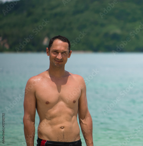 Portrait of a handsome happy man at tropical resort with smile