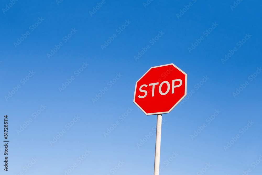 Stop sign against the blue sky.