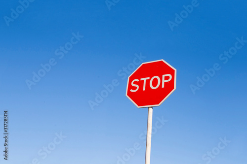 Stop sign against the blue sky.