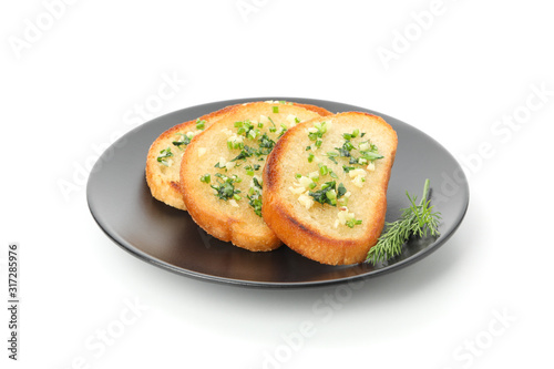 Plate of toasted bread slices with garlic isolated on white background