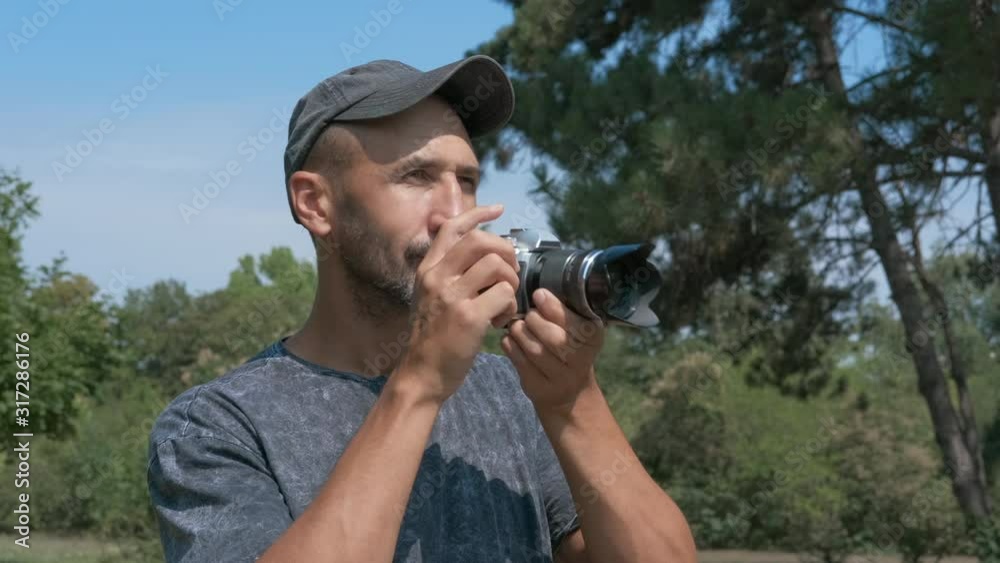 Tourist with camera in the field. Tourist with camera in the field.