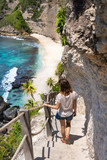 Young woman on the stairway to the beautiful diamond beach, Nusa Penida island