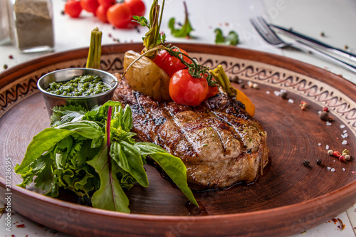 Картината върху платно Pork entrecote served with grilled vegetables, mushrooms and pesto sauce, restau