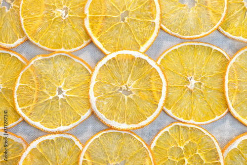 Slices of dried orange on a gray cloth. Fruit background.