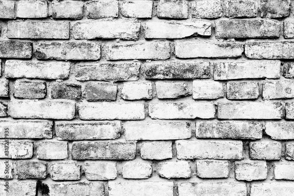 Texture of a brick wall with cracks and scratches which can be used as a background Texture of a brick wall with cracks and scratches which can be used as a background