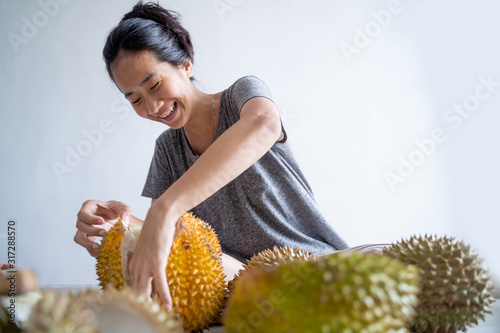 beautiful asian woman eating durian fruit at home photo