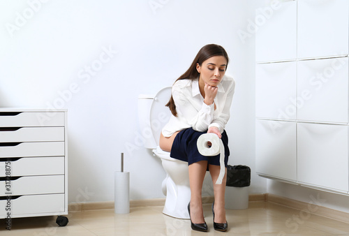Εκτύπωση καμβά Upset woman sitting on toilet bowl in bathroom