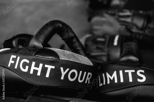 Obraz na plátně Close up of FIGHT YOUR LIMITS word on black boxing and kicking practice pad