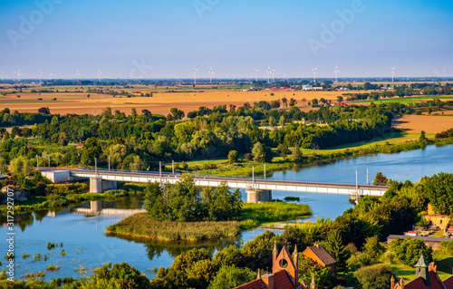 Aerial panoramic view of the Nogat river with a railway bridge by the medieval Teutonic Order Castle in Malbork, Poland