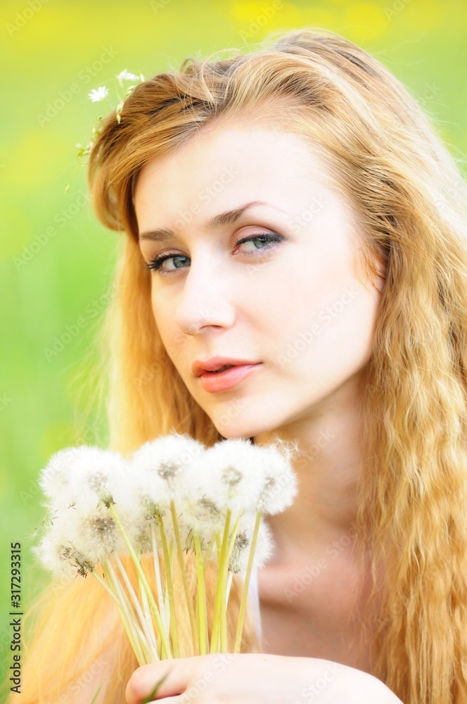 Portrait of a young girl with dandelions in her hands Portrait of a young girl with dandelions in her hands