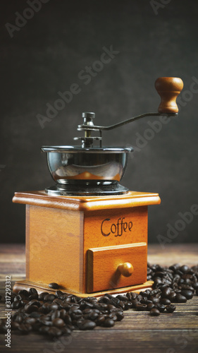 Coffee beans and wooden coffee grinder.