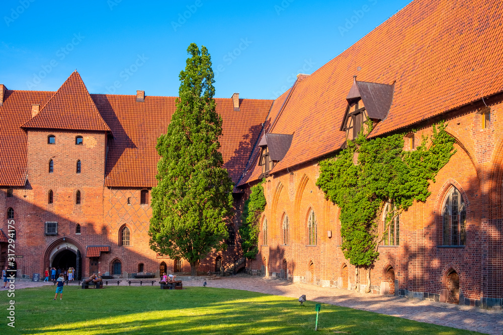 Middle Castle fortress inner courtyard with the gate tower of the Medieval Teutonic Order Castle in Malbork, Poland Middle Castle fortress inner courtyard with the gate tower of the Medieval Teutonic Order Castle in Malbork, Poland