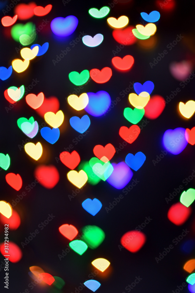 Heart. Abstract bokeh lights in colorful little heart shape on black background. Christmas and valentines day. Blurred vertical background. Heart. Abstract bokeh lights in colorful little heart shape on black background. Christmas and valentines day. Blurred vertical background.