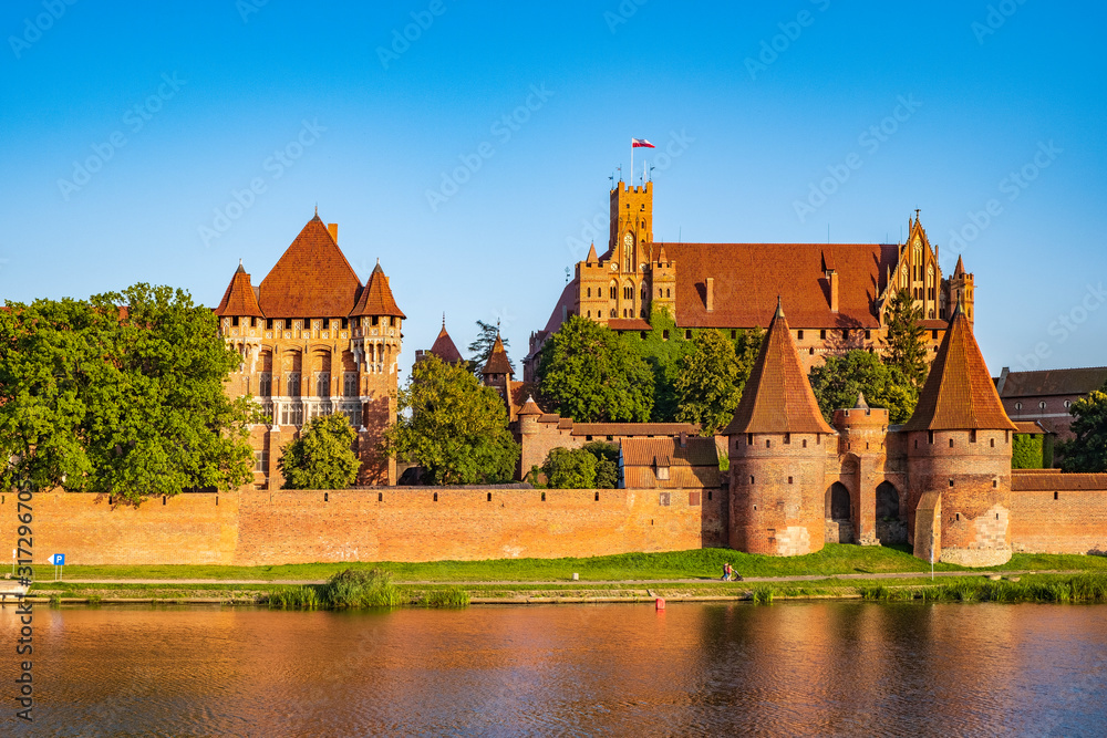 Panoramic view of the defense walls and towers of the Medieval Teutonic Order Castle in Malbork, Poland from across the Nogat river