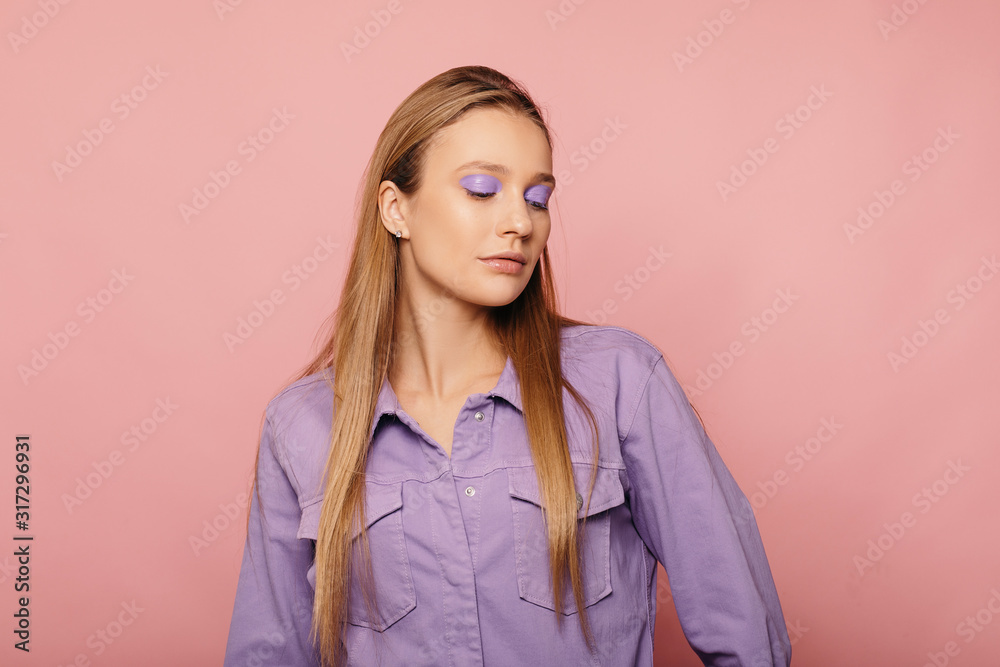 Studio portrait of gorgeous bloinde woman posing on bold background