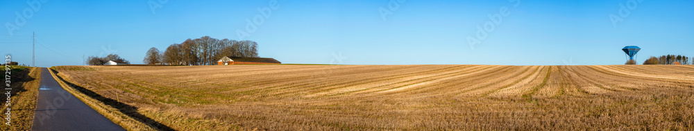 Rural panorama landscape with a dry field