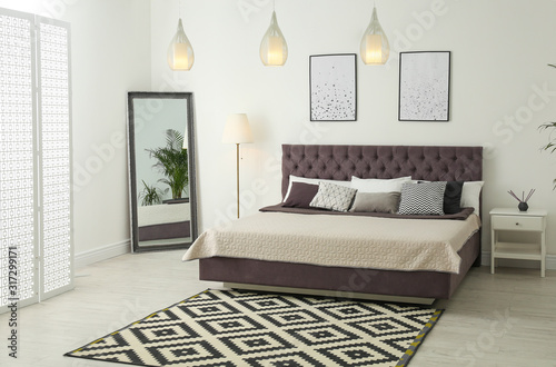 Elegant interior of modern comfortable bedroom with mirror