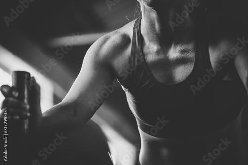 Photos Female fitness model pushing a sled in a cross fit gym.