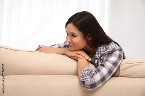 Young woman relaxing on couch at home