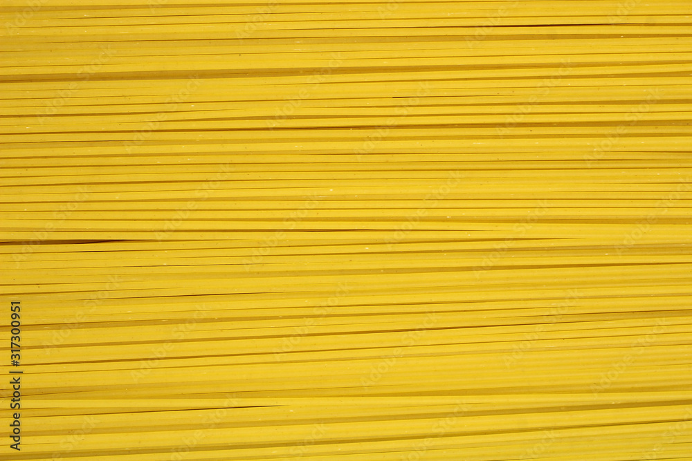 Yellow long spaghetti in rows. Food background, texture Yellow long spaghetti in rows. Food background, texture