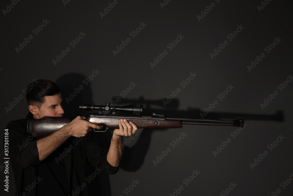 Professional killer with sniper rifle on black background Professional killer with sniper rifle on black background