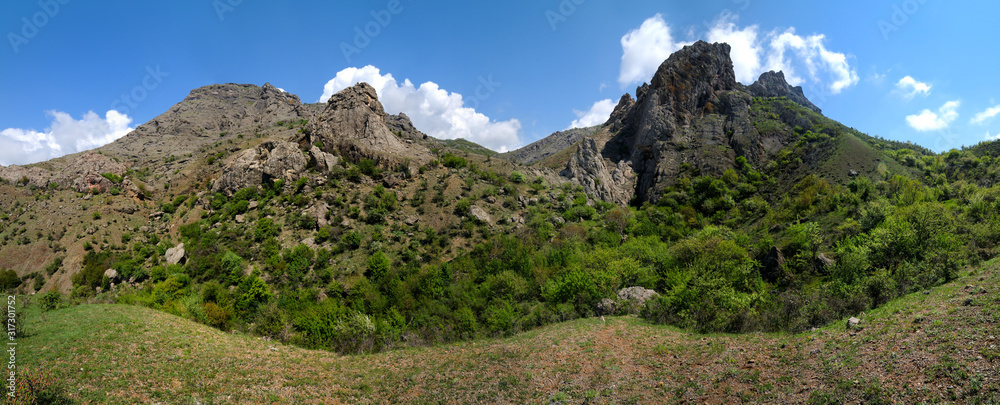 Mountain landscape and small village in distance Mountain landscape and small village in distance
