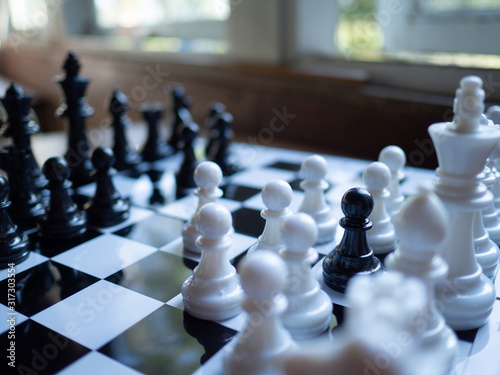 The black pawn sound by white chesses to demonstrate the business strategy. The spy. To find out the best solution to get to the needs of market