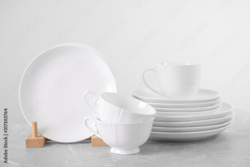 Set of clean tableware on light grey marble table Set of clean tableware on light grey marble table