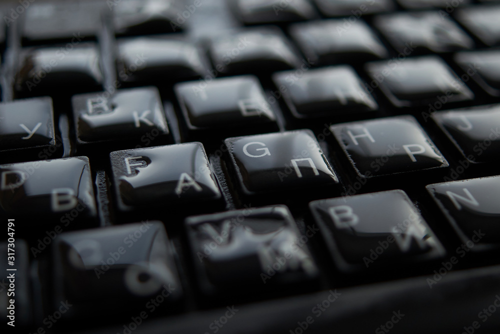 drops of water on a black keyboard
