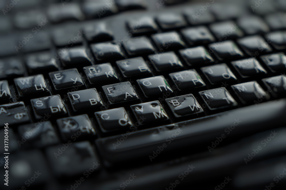  drops of water on a black keyboard