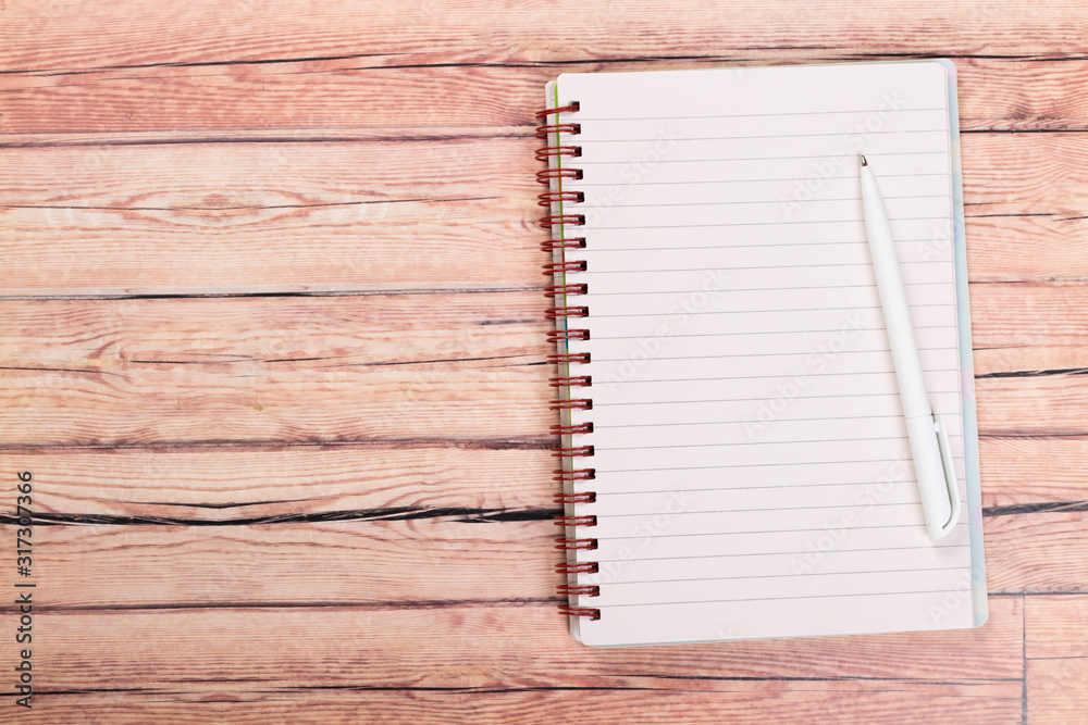 blank notebook with pen on a wooden table, business concept concept of a new workplace blank notebook with pen on a wooden table, business concept concept of a new workplace