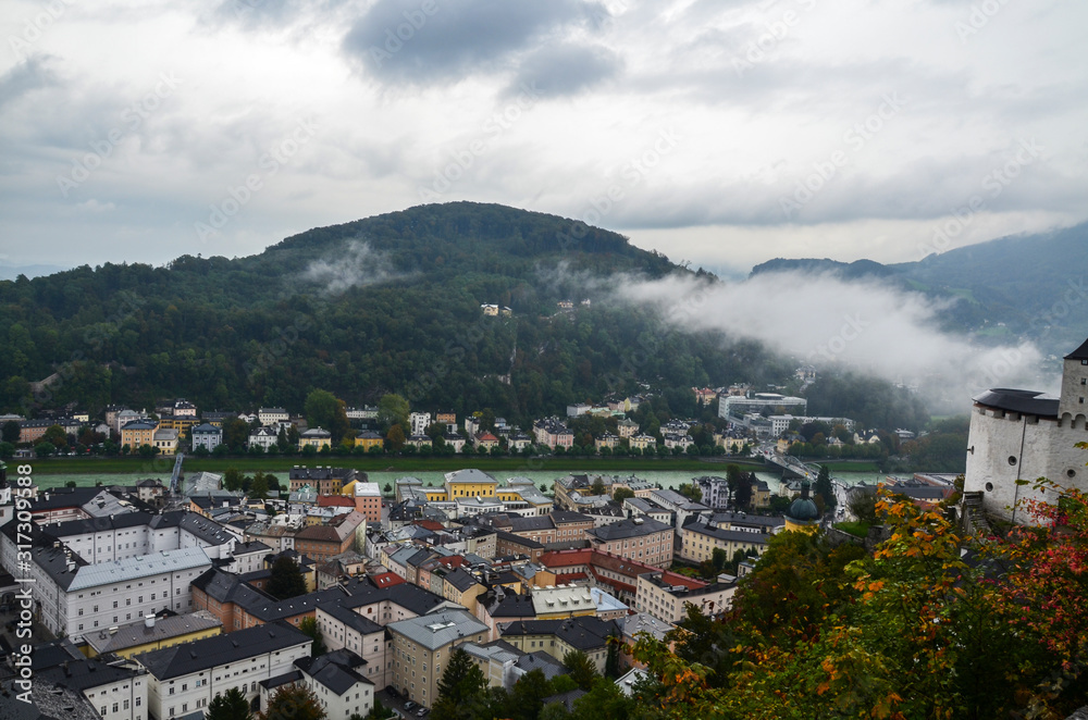 Top view of the Salzach river and the old city in center of Salzburg, Austria, from the walls of the fortress in cloudy autumn day 