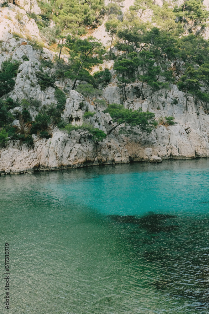 Beautiful beach with turquoise water and rocky cliffs in Calanques National Park.