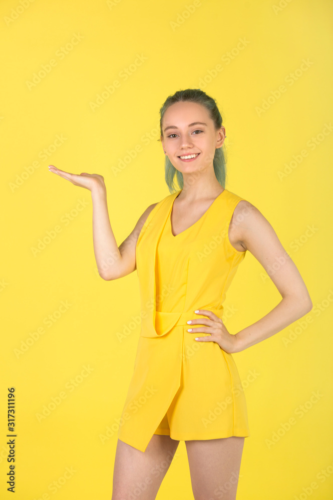 beautiful young woman in a yellow dress on a yellow background beautiful young woman in a yellow dress on a yellow background